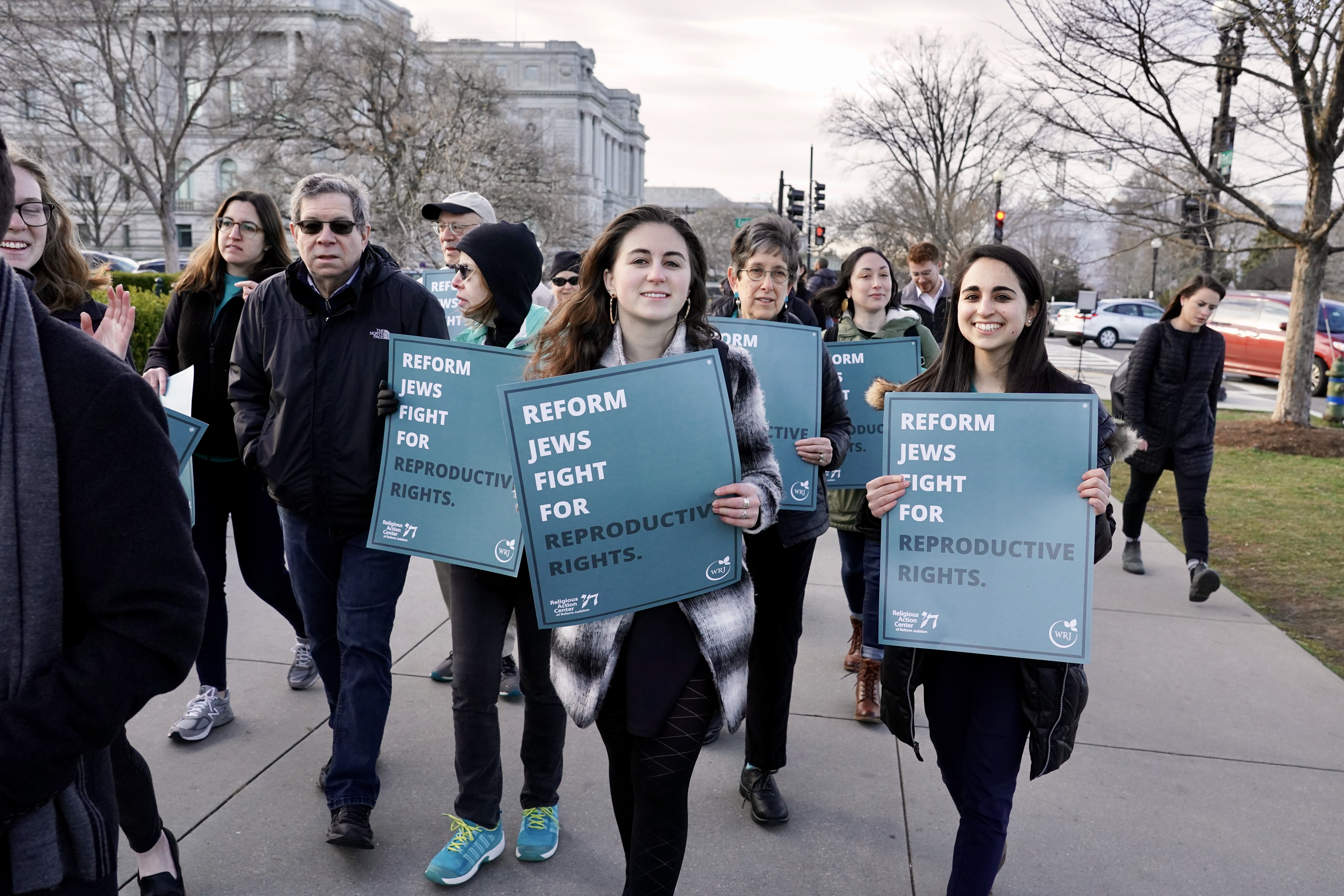 Women carrying signs to fight for reproductive rights