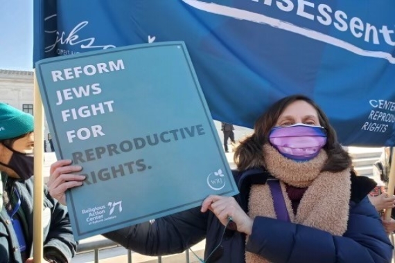 Shoshana holding an abortion access rally sign