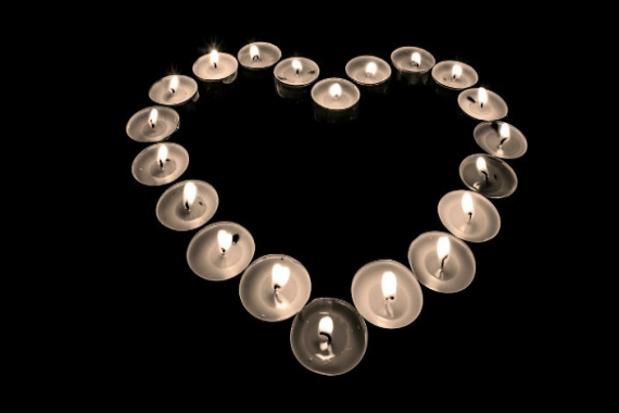 Small candles lit in the shape of a heart 